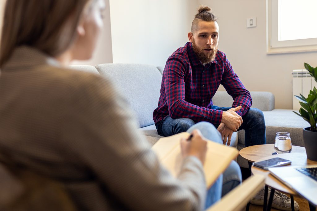 Person researching rehab facility options for addiction recovery