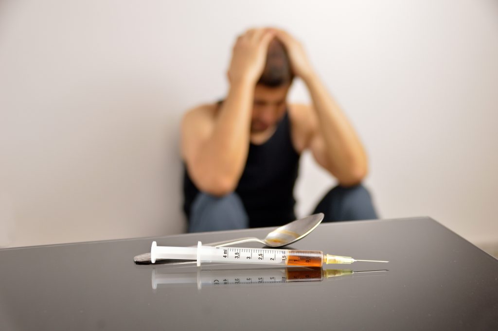 Illustration showing the physical symptoms of addiction, such as changes in appearance, health issues, and withdrawal signs.