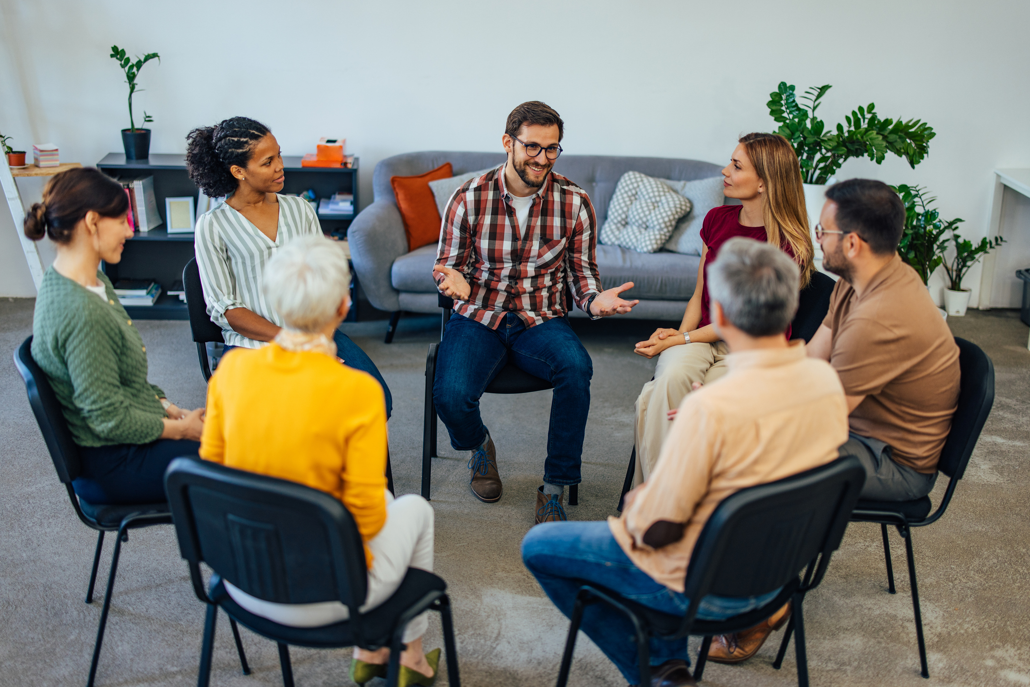Support group members engaging in discussion for substance abuse recovery