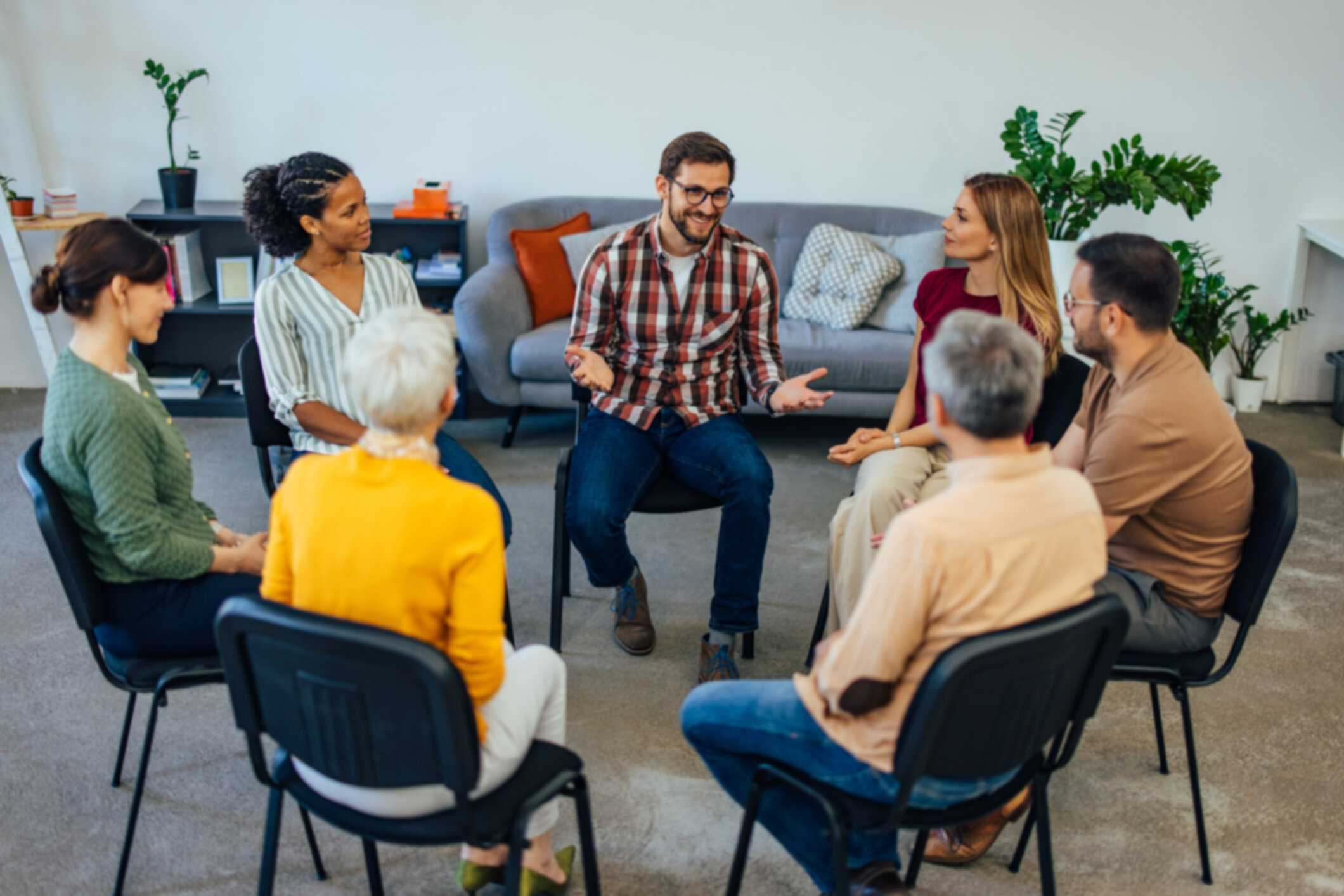 Support group members engaging in discussion for substance abuse recovery