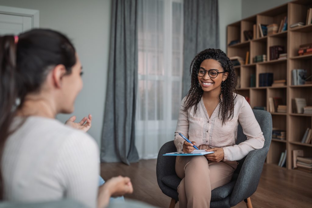 A therapist and patient engaged in a counseling session focused on recovery