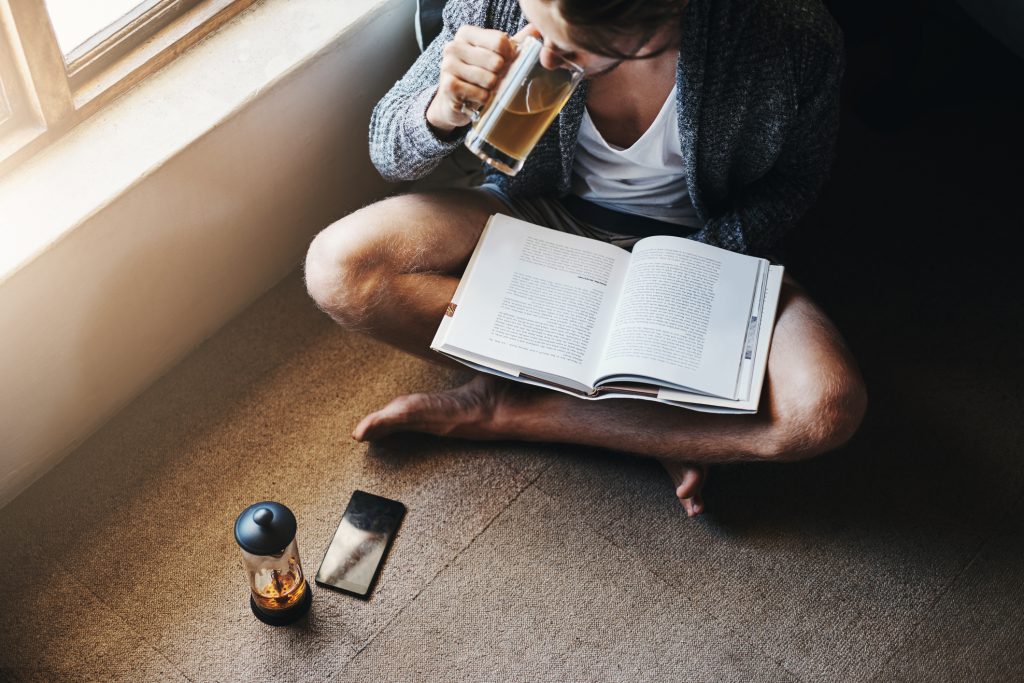 A person reading about addiction and its effects on health and behavior
