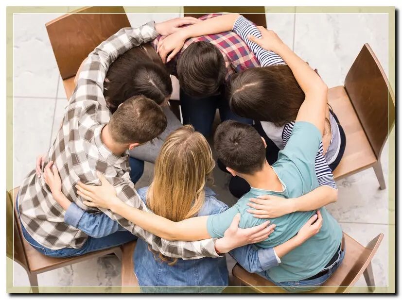 Individuals engaging in prayer and group counseling at a faith-based rehab center, experiencing the benefits of spiritual support in addiction recovery."