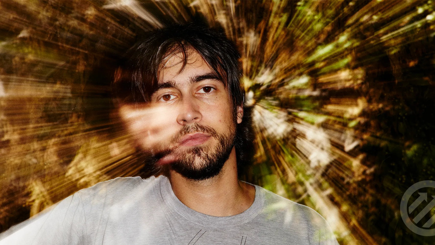 Alex G performing live on stage with a guitar, known for his introspective indie music and abstract lyrics.