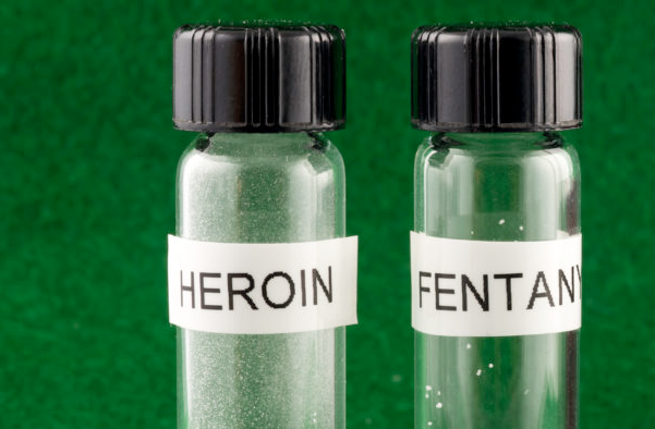 Used syringes and drug paraphernalia represent the dangers of heroin and fentanyl abuse.