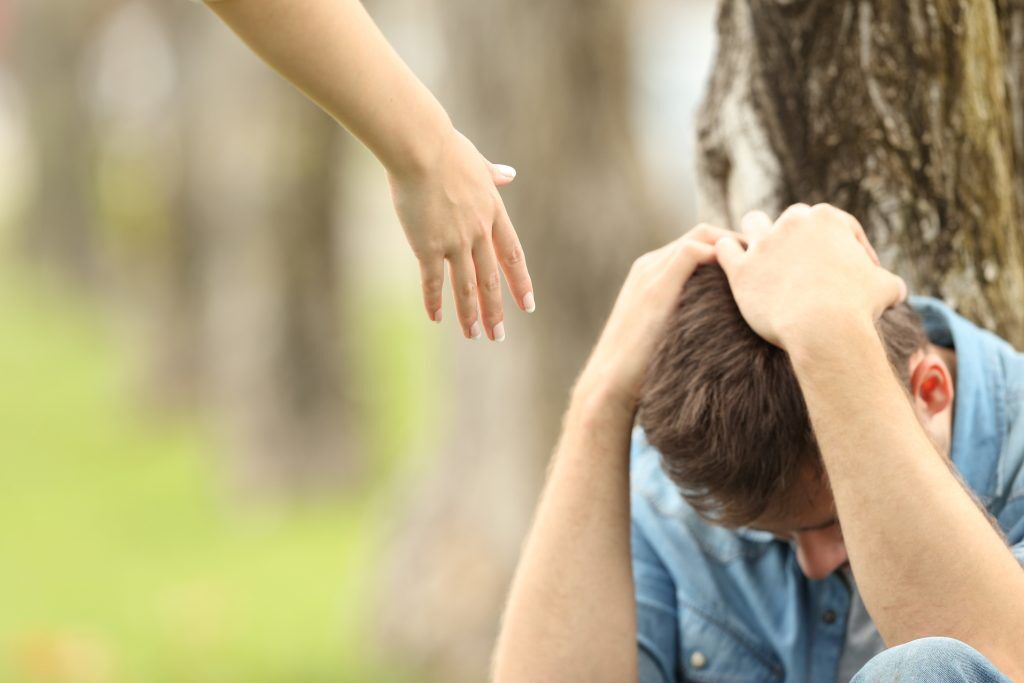 A person reaching out for support, highlighting the significance of seeking help during challenging times.